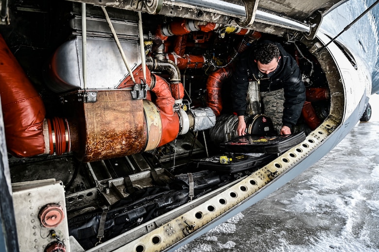 Senior Airman Kawika Hasson, 911th Aircraft Maintenance Squadron electrical and environmental specialist, grabs tools needed to conduct maintenance on a C-17 Globemaster III at the Pittsburgh International Airport Air Reserve Station, Pennsylvania, Feb. 16, 2021.