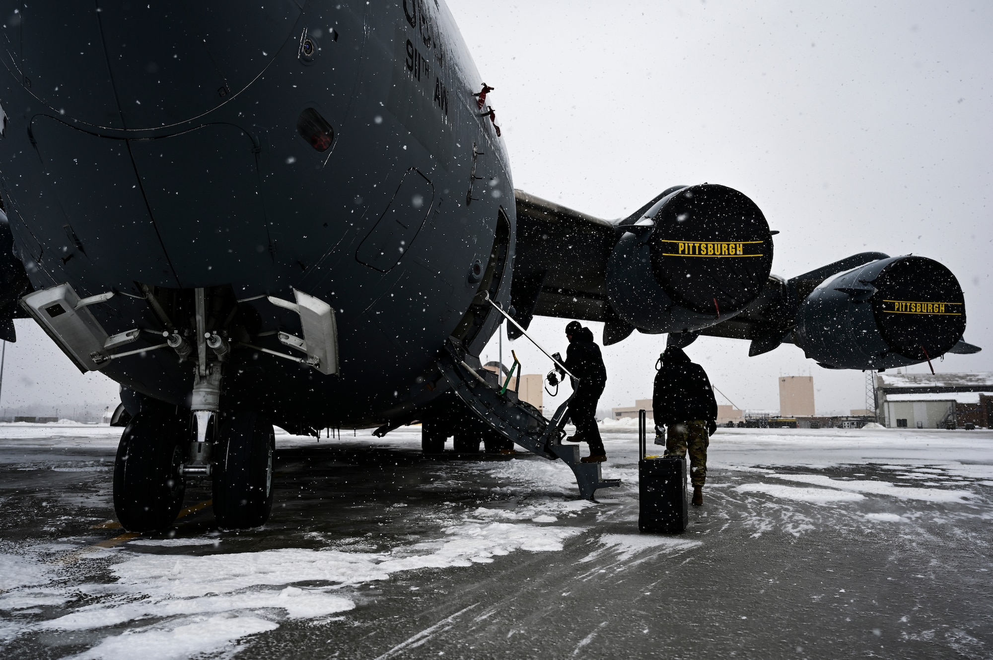 Airmen assigned to the 911th Aircraft Maintenance Squadron prepare to conduct routine maintenance on a C-17 Globemaster III at the Pittsburgh International Airport Air Reserve Station, Pennsylvania, Feb. 16, 2021.