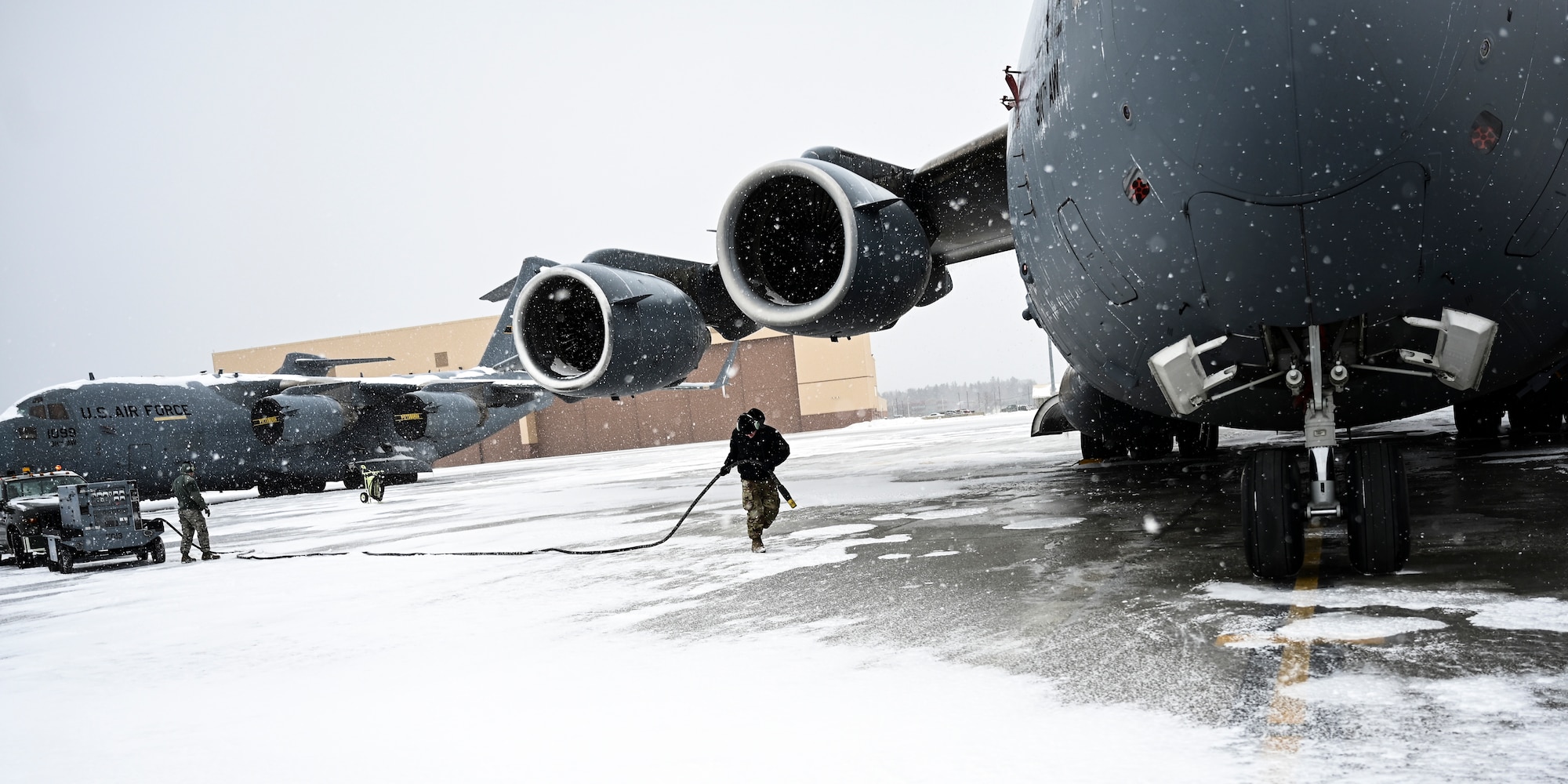Master Sgt. Timothy Schurr, 911th Aircraft Maintenance Squadron guidance and controls technician, pulls a power cord from a generator to a C-17 Globemaster III in order to conduct routine maintenance at the Pittsburgh International Airport Air Reserve Station, Pennsylvania, Feb. 16, 2021.