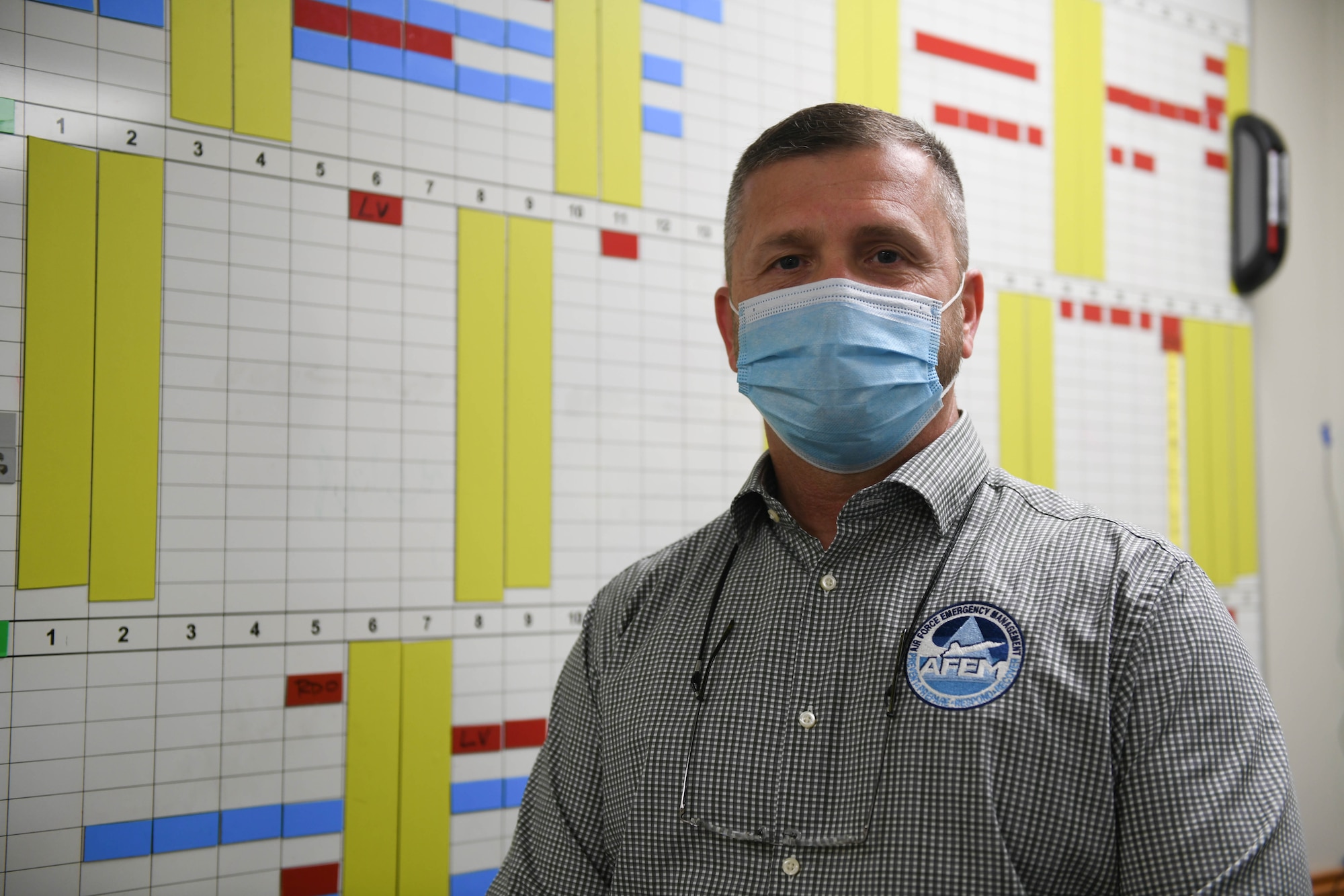 A non-uniformed Tyndall member poses for a photo in his office.