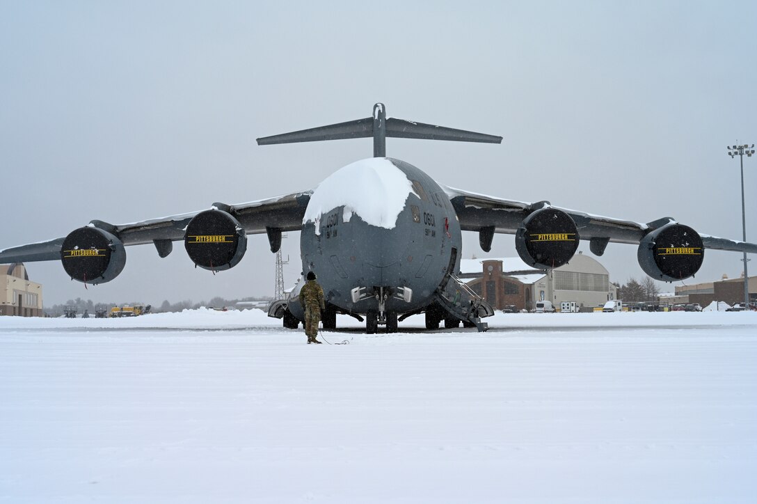 Senior Airman Evan Henry, crew chief with the 911th Aircraft Maintenance Squadron, tests the communications equipment onboard a C-17 Globemaster III at Pittsburgh International Airport Air Reserve Station, Pennsylvania, Feb. 1, 2021.