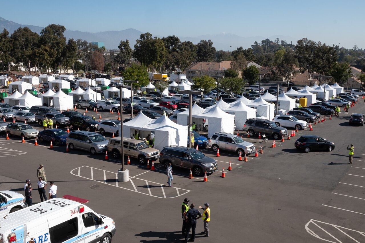 Cars move through a drive-thru vaccination site in California.