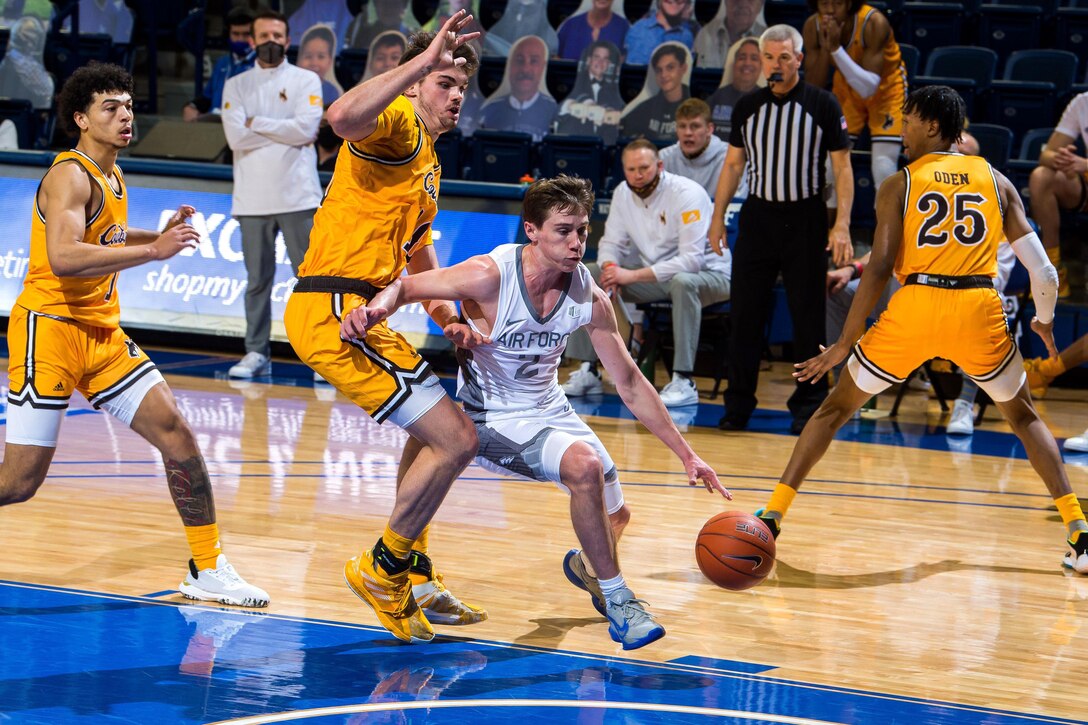 Men play basketball.