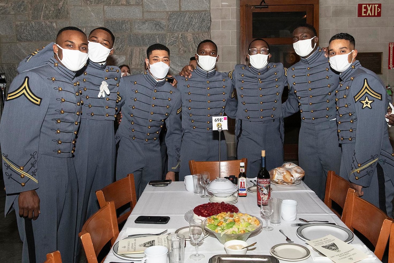 Cadets stand around a table.