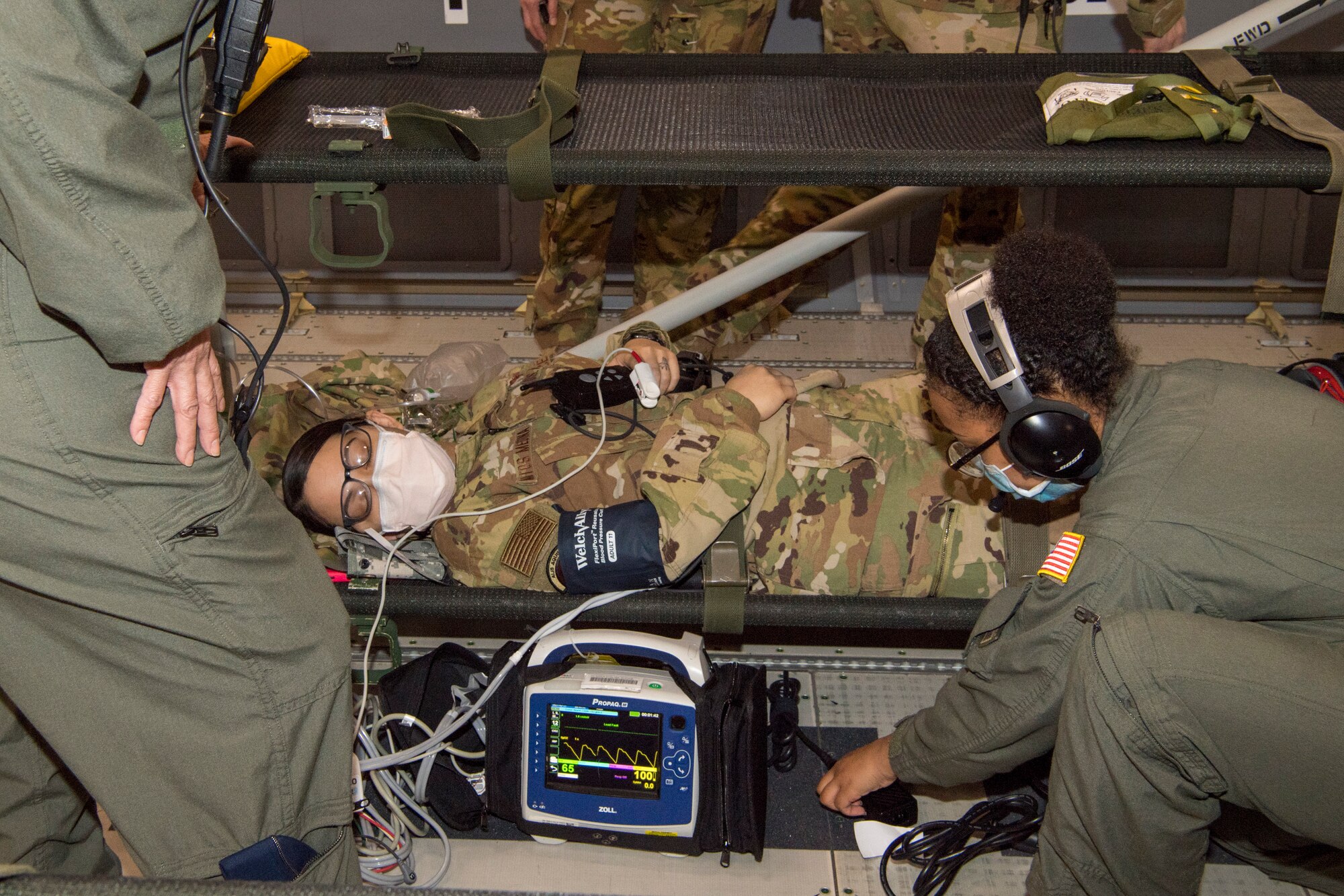U.S. Air Force Reserve Citizen Airmen from the 514th Aeromedical Evacuation Squadron check vitals on and care for a simulated patient during a training mission to Isla Verde, Puerto Rico, with Air Force Reserve Command, Air Mobility Command, and the 916th Air Refueling Wing Feb. 26, 2021. Members from the 514th AES were evaluated on many different scenarios designed to replicate real-world combat medical service while aboard the KC-46 Pegasus. The instructors were from the Air Force Reserve Command and Air Mobility Command. (U.S. Air Force photo by Senior Airman Ruben Rios)
