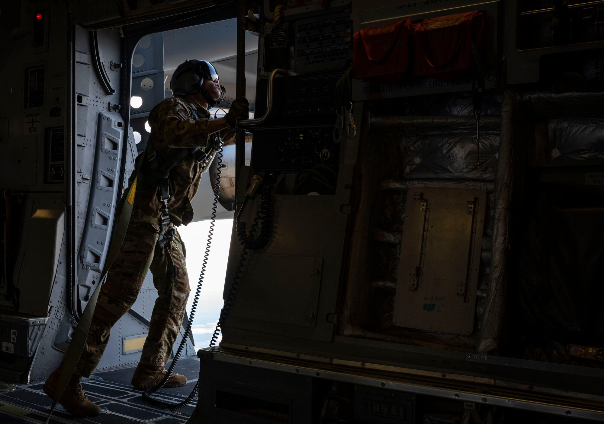 U.S. Air Force Senior Airman Keoni Gibson, 8th Airlift Squadron loadmaster, checks the perimeter of a door on a C-17 Globemaster III assigned to the 62nd Airlift Wing, Joint Base Lewis-McChord, Washington, prior to a static-line jump during Exercise Predictable Iron at Pope Army Airfield, Fort Bragg, North Carolina, Feb. 25, 2021. The exercise provided the opportunity for the U.S. Air Force and U.S. Army to strengthen their skill sets together and accomplish the Department of Defense’s mission to provide combat-credible military forces. (U.S. Air Force photo by Staff Sgt. Rachel Williams)
