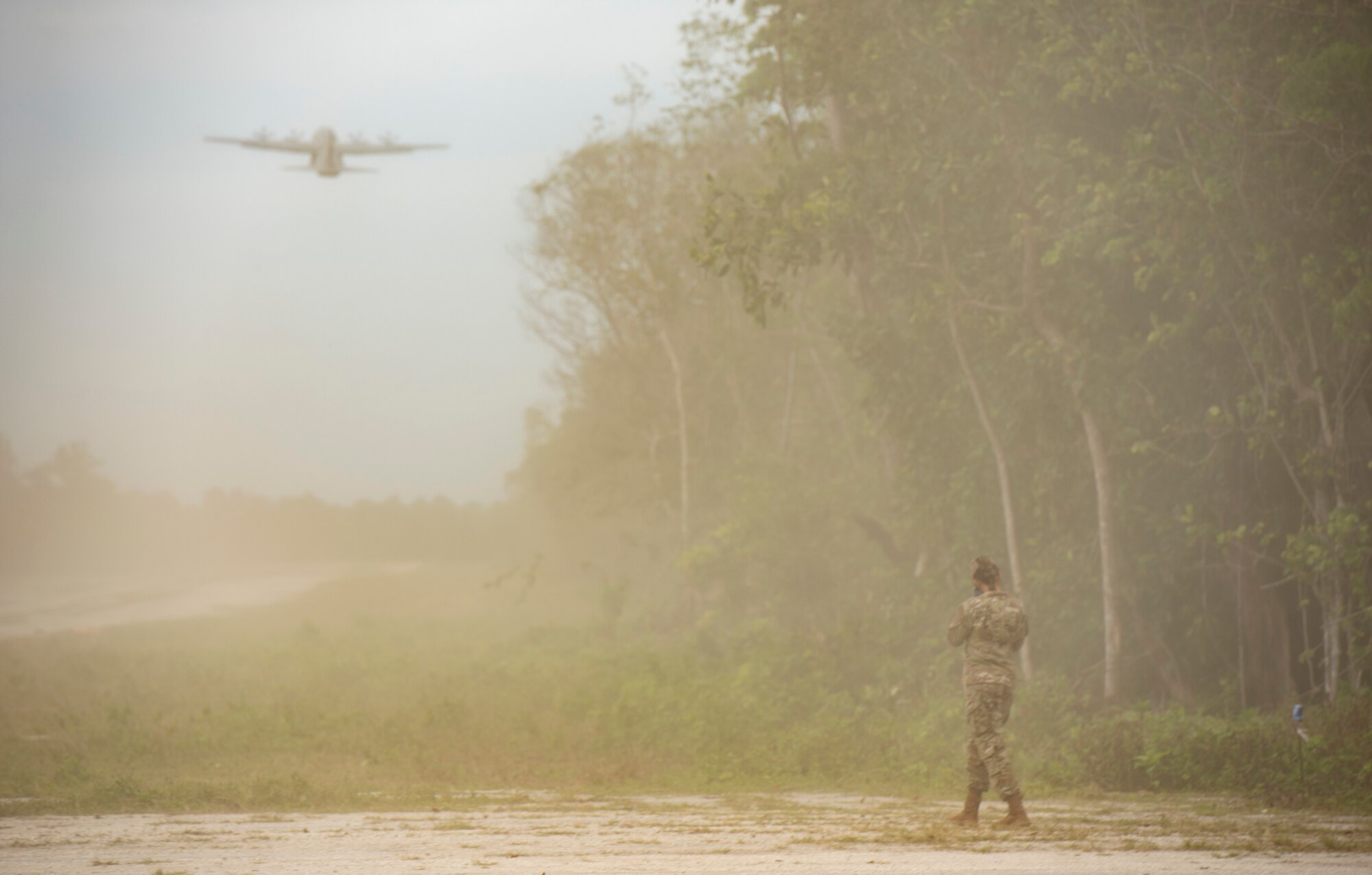 A U.S. Air Force C-130J Super Hercules, assigned to Yokota Air Base, Japan, kicks up a cloud of dust after taking off from a rocky landing zone during Cope North 21, Feb. 11, 2021, on Angaur, Palau.