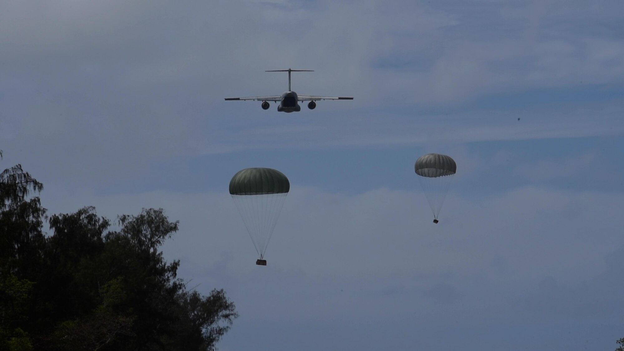 A Koku-Jieitai Kawasaki C-2, assigned to the 403rd Squadron from Miho Air Base, airdrops two packages during Cope North 21, Feb. 11, 2021, on Angaur, Palau.