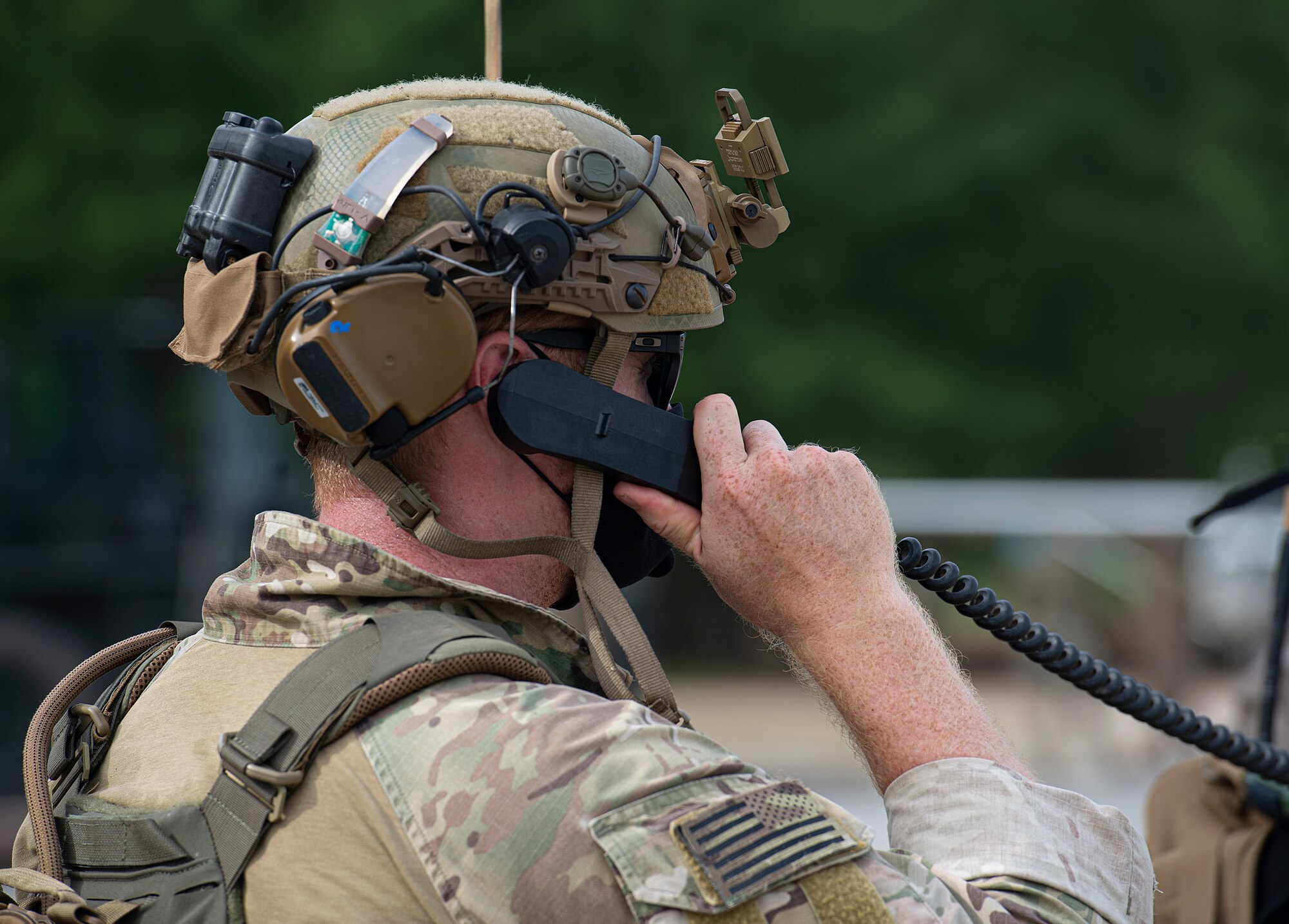 U.S. Air Force Major Ryan Kiggins, 736th Security Forces Squadron commander, speaks with a Koku-Jieitai Kawasaki C-2 pilot minutes before an airdrop during Cope North 21, Feb. 10, 2021, on Angaur, Palau.