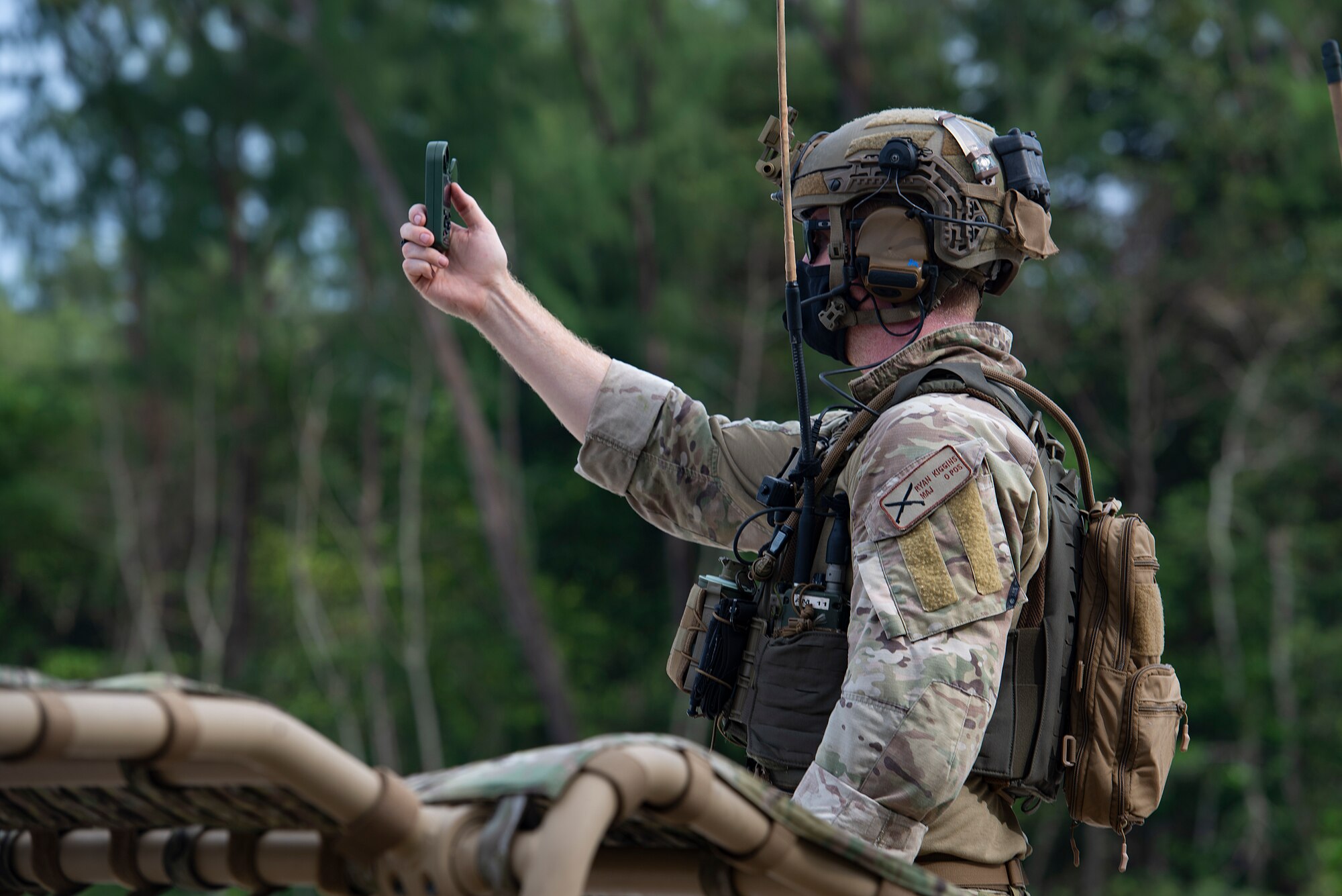 U.S. Air Force Major Ryan Kiggins, 736th Security Forces Squadron commander, checks wind speeds before an airdrop during Cope North 21, Feb. 10, 2021, on Angaur, Palau.