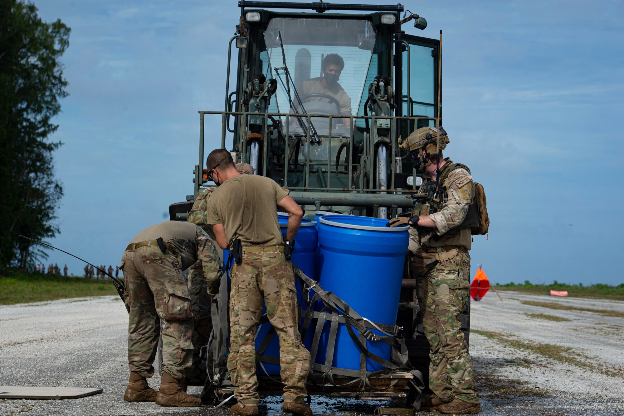 U.S. Air Force Airmen assigned to the 36th Contingency Response Group secure an airdropped package to a forklift to be transported during Cope North 21, Feb. 10, 2021, on Angaur, Palau.