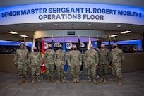 military leaders stand in a room