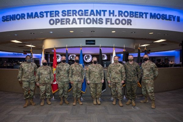 military leaders stand in a room