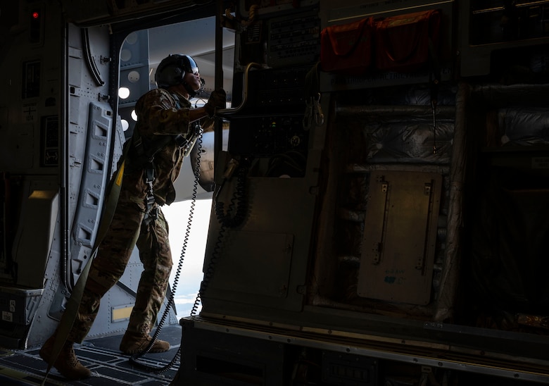 Senior Airman Keoni Gibson, 8th Airlift Squadron loadmaster, checks the perimeter of a door on a C-17 Globemaster III assigned to the 62nd Airlift Wing, Joint Base Lewis-McChord, Wash., prior to a static-line jump during Exercise Predictable Iron at Pope Army Airfield, Fort Bragg, N.C., Feb. 25, 2021. The exercise provided the opportunity for the U.S. Air Force and U.S. Army to strengthen their skill sets together and accomplish the Department of Defense's mission to provide combat-credible military forces.