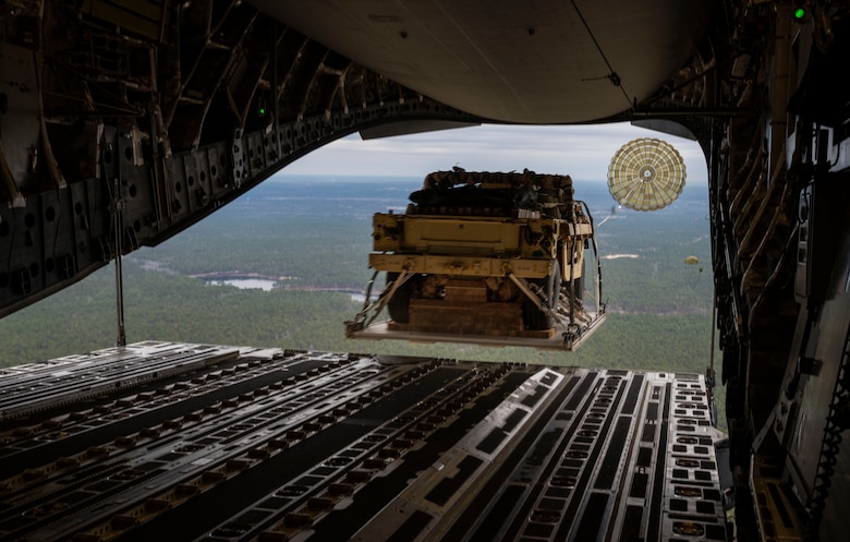A Humvee is airdropped from a C-17 Globemaster III, assigned to the 62nd Airlift Wing, Joint Base Lewis-McChord, Wash., during Exercise Predictable Iron at Pope Army Airfield, Fort Bragg, N.C., Feb. 26, 2021. Members with the 62nd AW conducted airdrop and personnel drop missions with the 82nd Airborne Division, promoting the integration of mobility capabilities into joint warfighting concepts.