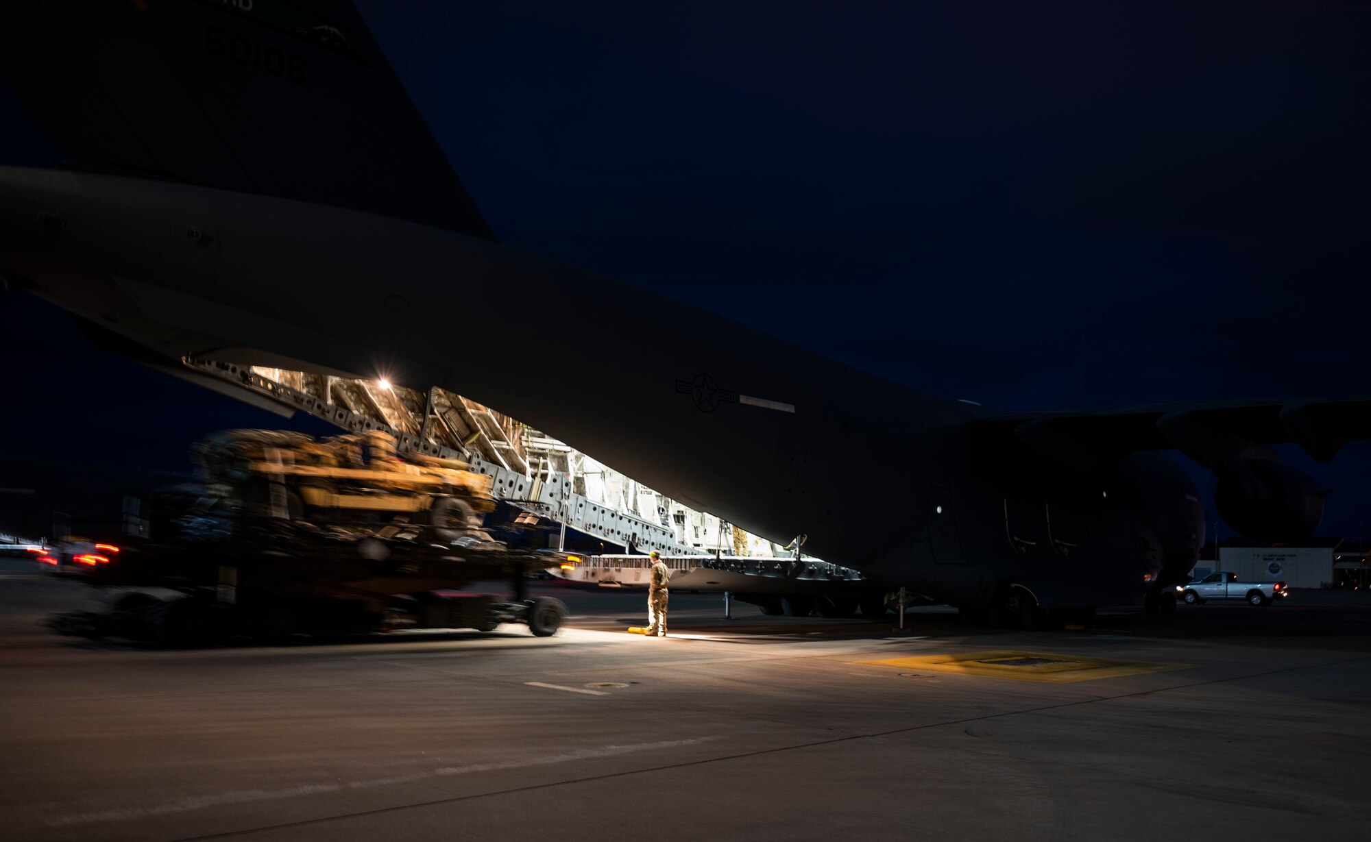 U.S. Air Force Airmen and U.S. Army Soldiers load a Humvee onto a C-17 Globemaster III, assigned to the 62nd Airlift Wing, Joint Base Lewis-McChord, Washington, prior to an airdrop mission during Exercise Predictable Iron at Pope Army Airfield, Fort Bragg, North Carolina, Feb. 26, 2021. Members with the 62nd AW conducted airdrop and personnel drop missions with the 82nd Airborne Division, promoting the integration of Mobility Air Force capabilities into joint warfighting concepts. (U.S. Air Force photo by Staff Sgt. Rachel Williams)