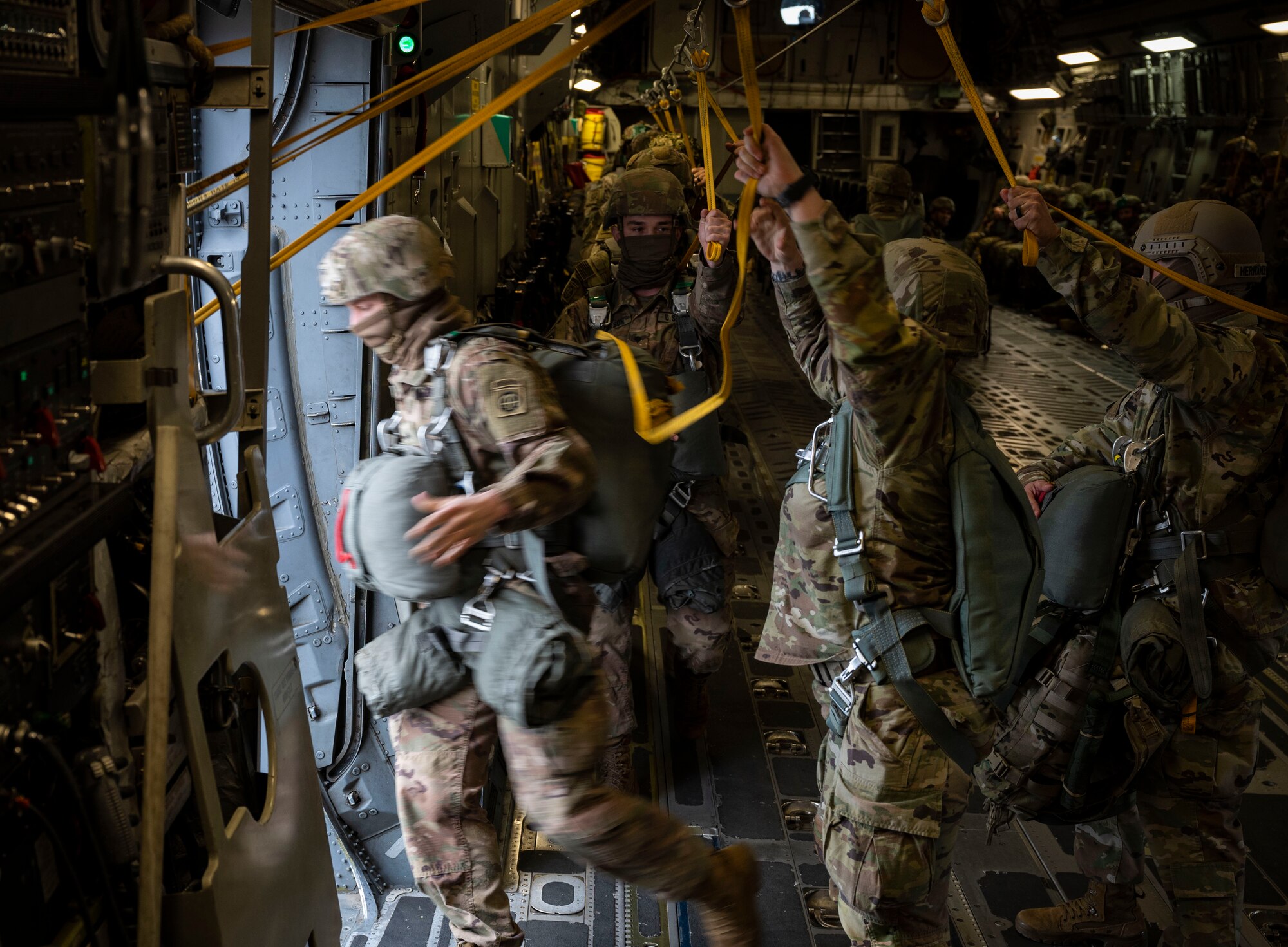 U.S. Soldiers with the 82nd Airborne Division execute a static-line jump out of a C-17 Globemaster III, assigned to the 62nd Airlift Wing, Joint Base Lewis-McChord, Washington, during Exercise Predictable Iron at Pope Army Airfield, Fort Bragg, North Carolina, Feb. 26, 2021. Members with the 62nd AW conducted airdrop and personnel drop missions with the 82nd Airborne Division, promoting the integration of Mobility Air Force capabilities into joint warfighting concepts. (U.S. Air Force photo by Staff Sgt. Rachel Williams)