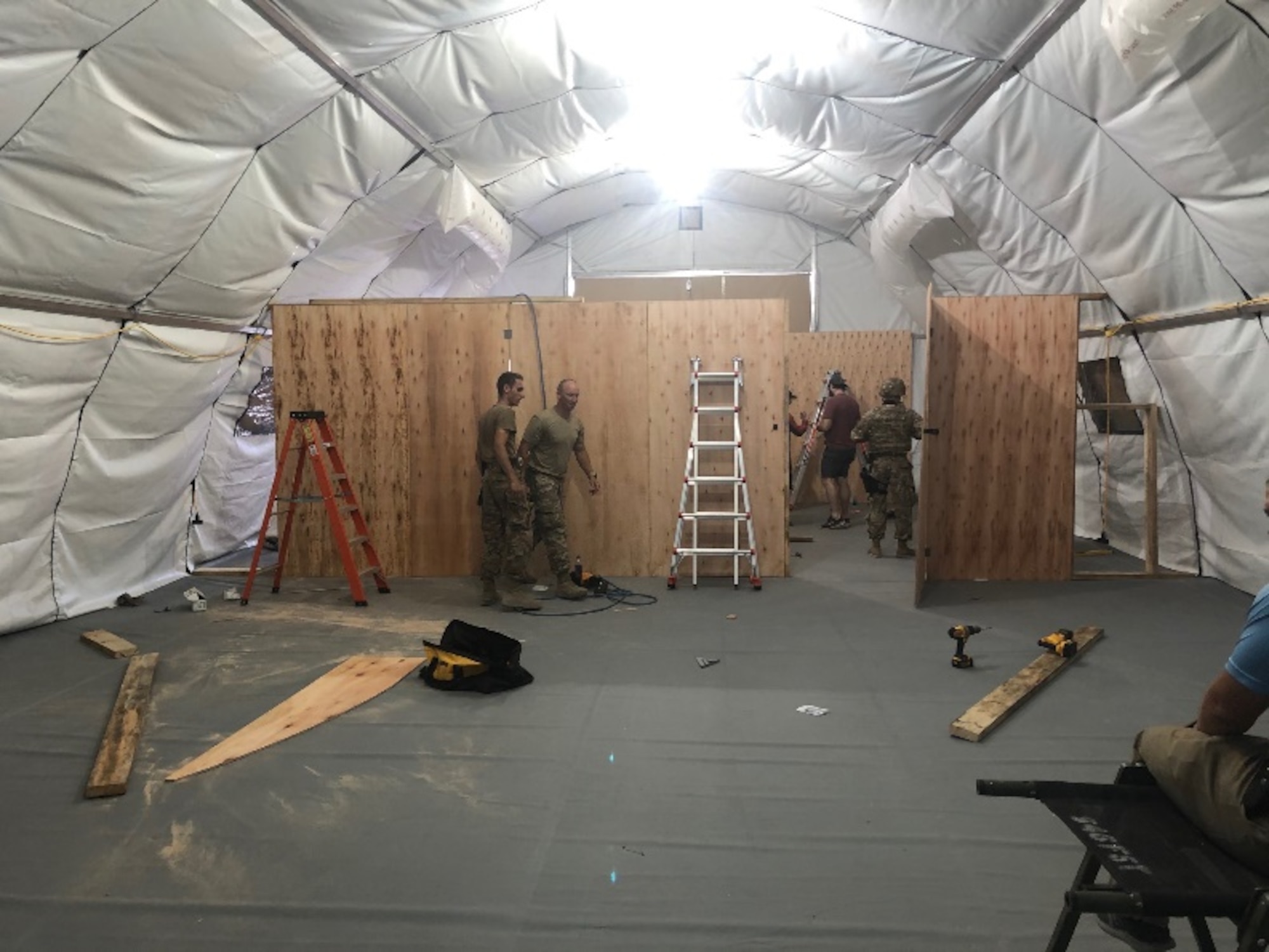 Airmen with the 435th Air Ground Operations Wing and the 435th Air Expeditionary Wing work together to construct a field resuscitative surgical tent at a base in East Africa, Dec. 15, 2020. Airmen of the 435th AGOW and 435th AEW took part in the movement of personnel and cargo to support Operation Octave Quartz. (Courtesy photo)