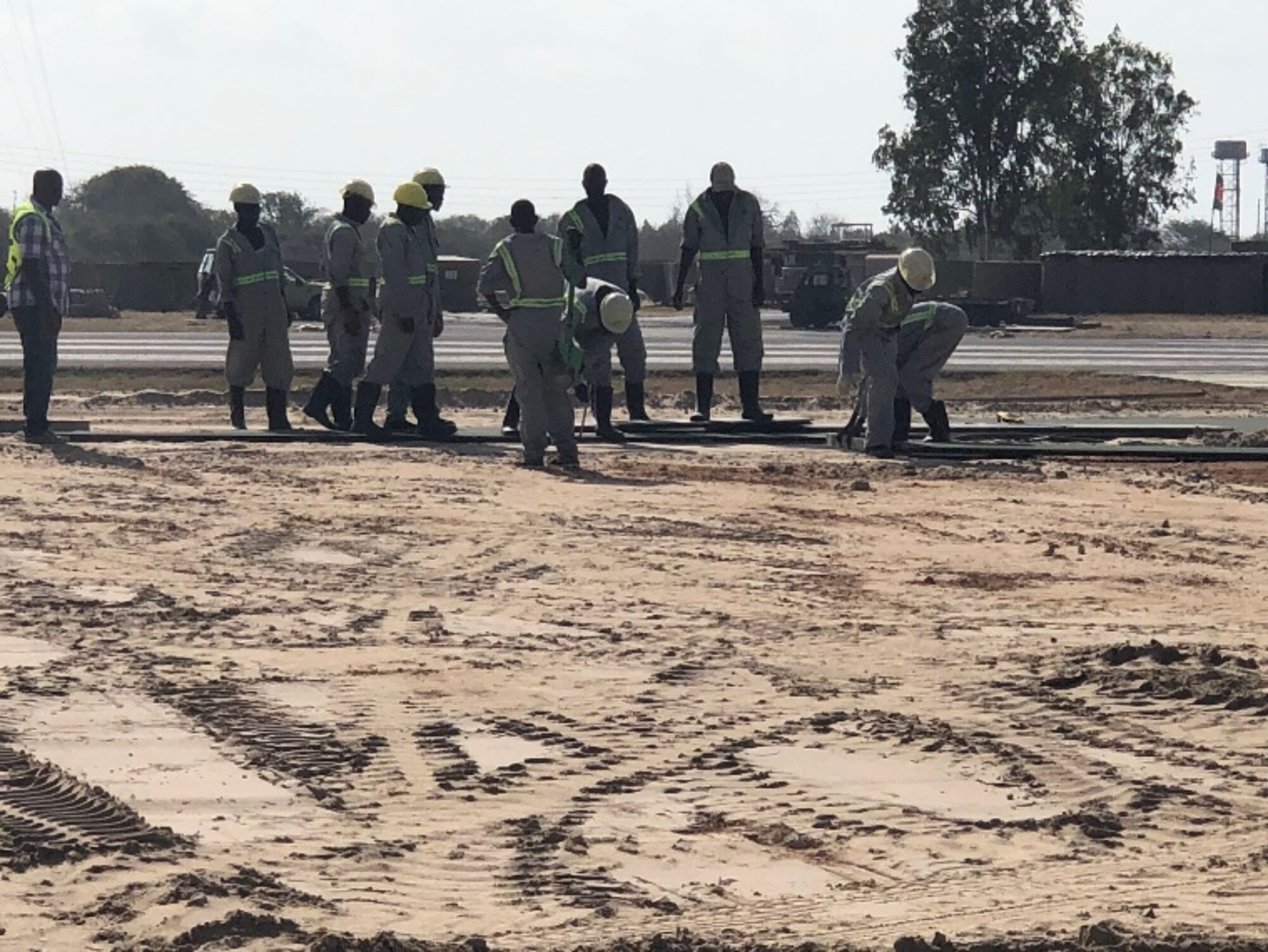 Contractors build helicopter pads to support a base build-out tasker in support of Operation Octave Quartz at a base in East Africa, Dec. 23, 2020. Airmen of the 435th Air Ground Operations Wing and 435th Air Expeditionary Wing took part in the movement of personnel and cargo to support OOQ. (Courtesy photo)