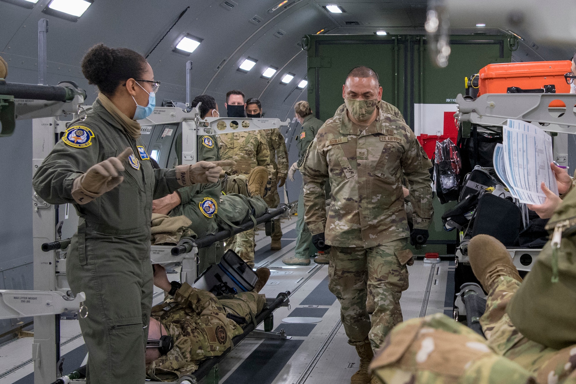 U.S. Air Force Reserve Citizen Airmen from the 514th Aeromedical Evacuation Squadron check vitals on and care for a simulated patient during a training mission to Isla Verde, Puerto Rico, with Air Force Reserve Command, Air Mobility Command, and the 916th Air Refueling Wing Feb. 26, 2021. Members from the 514th AES were evaluated on many different scenarios designed to replicate real-world combat medical service while aboard the KC-46 Pegasus. The instructors were from the Air Force Reserve Command and Air Mobility Command. (U.S. Air Force photo by Senior Airman Ruben Rios)