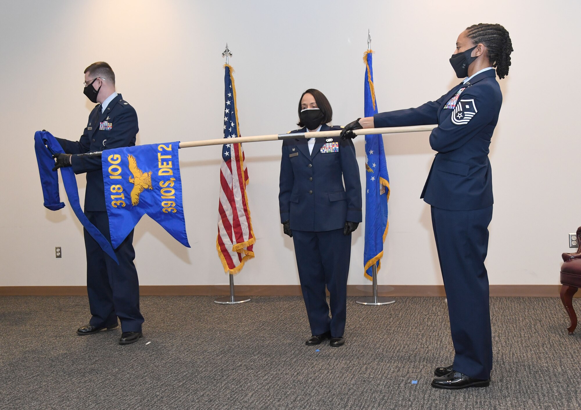 U.S. Air Force Lt. Col. Jonathan Williams, 39th Information Operations Squadron commander, Hurlburt Field, Florida, and Maj. Omayra Genao, 39th Information Operations Squadron Detachment 2 commander, unfurl the guidon during an activation ceremony inside the Roberts Consolidated Aircraft Maintenance Facility at Keesler Air Force Base, Mississippi, Feb. 22, 2021. Brig. Gen. Chad Raduege, Director of Cyberspace and Information Dominance and Chief Information Officer, Headquarters Air Combat Command, Joint Base Langley Eustis, Virginia, and Lauren Knausenberger, Chief Information Officer for the Department of the Air Force, comprised of the U.S. Air Force and U.S. Space Force, the Pentagon, Virginia, attended the ceremony and an 81st Training Group immersion tour. (U.S. Air Force photo by Kemberly Groue)