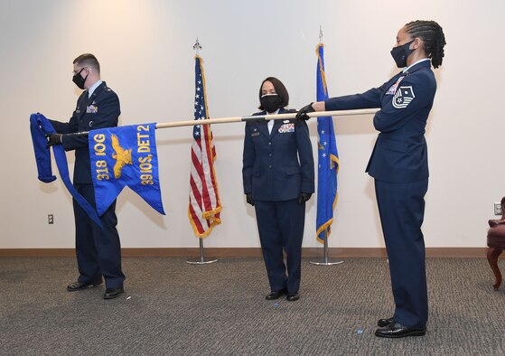 U.S. Air Force Lt. Col. Jonathan Williams, 39th Information Operations Squadron commander, Hurlburt Field, Florida, and Maj. Omayra Genao, 39th Information Operations Squadron Detachment 2 commander, unfurl the guidon during an activation ceremony inside the Roberts Consolidated Aircraft Maintenance Facility at Keesler Air Force Base, Mississippi, Feb. 22, 2021. Brig. Gen. Chad Raduege, Director of Cyberspace and Information Dominance and Chief Information Officer, Headquarters Air Combat Command, Joint Base Langley Eustis, Virginia, and Lauren Knausenberger, Chief Information Officer for the Department of the Air Force, comprised of the U.S. Air Force and U.S. Space Force, the Pentagon, Virginia, attended the ceremony and an 81st Training Group immersion tour. (U.S. Air Force photo by Kemberly Groue)