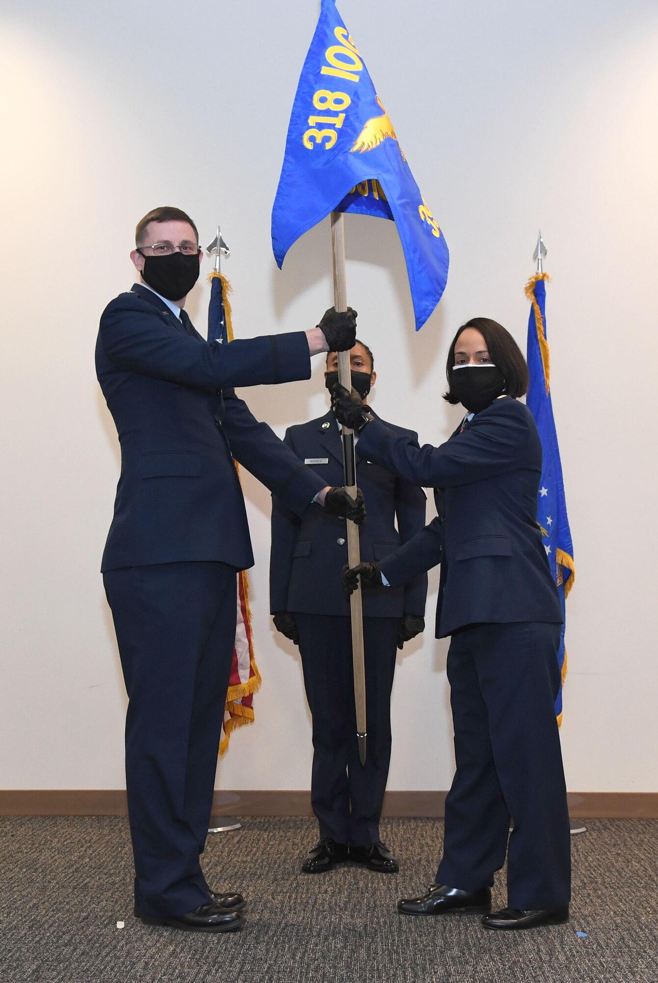 U.S. Air Force Lt. Col. Jonathan Williams, 39th Information Operations Squadron commander, Hurlburt Field, Florida, passes the guidon to Maj. Omayra Genao, 39th Information Operations Squadron Detachment 2 commander, during an activation ceremony inside the Roberts Consolidated Aircraft Maintenance Facility at Keesler Air Force Base, Mississippi, Feb. 22, 2021. Brig. Gen. Chad Raduege, Director of Cyberspace and Information Dominance and Chief Information Officer, Headquarters Air Combat Command, Joint Base Langley Eustis, Virginia, and Lauren Knausenberger, Chief Information Officer for the Department of the Air Force, comprised of the U.S. Air Force and U.S. Space Force, the Pentagon, Virginia, attended the ceremony and received an 81st Training Group immersion tour. (U.S. Air Force photo by Kemberly Groue)