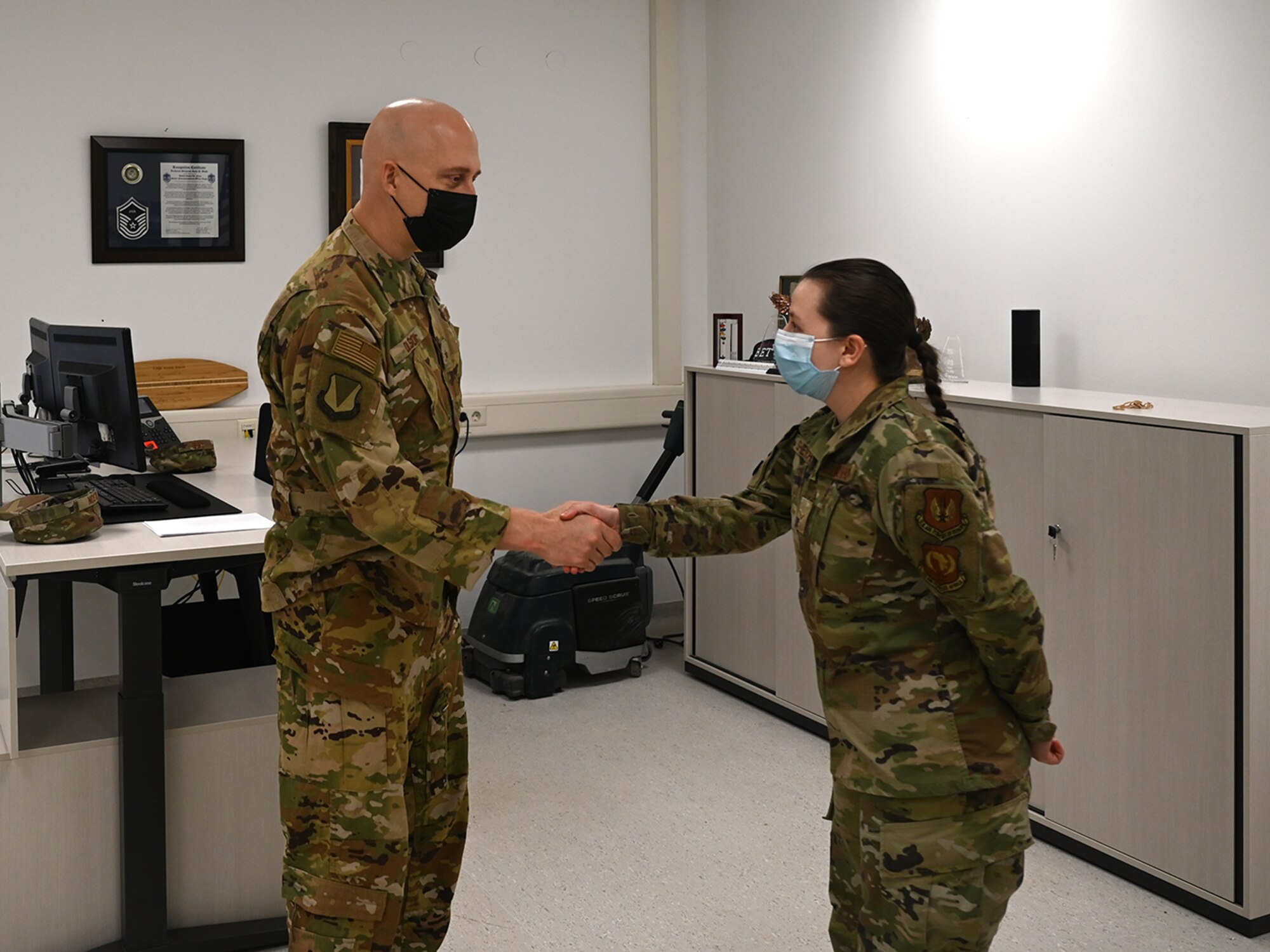U.S. Air Force Brig. Gen. Joshua Olson, 86th Airlift Wing commander, left, coins Airman 1st Class Mariia Shevchenko, 86th Maintenance Squadron precision measurement equipment laboratory apprentice, during an Airlifter of the Week ceremony