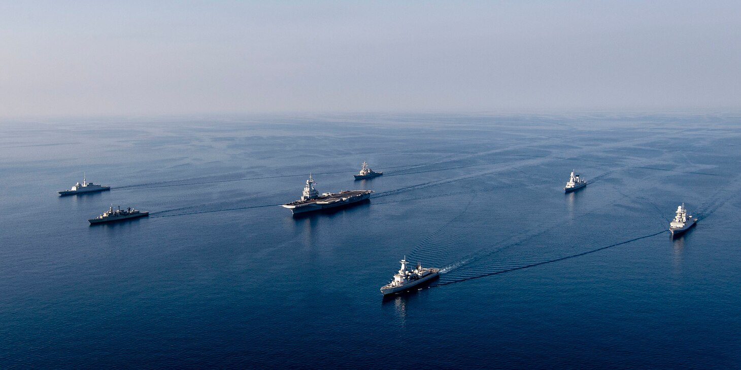 MEDITERRANEAN SEA (Feb. 28, 2021) The FS Charles De Gaulle (R 91) Carrier Strike Group sails in formation along with the Arleigh Burke-class guided-missile destroyer USS Donald Cook (DDG 75), during a photo exercise, Feb. 28, 2021. Donald Cook, forward-deployed to Rota, Spain, is on patrol in the U.S. Sixth Fleet area of operations in support of regional allies and partners and U.S. national security in Europe and Africa. (U.S. Navy photo courtesy French Navy)