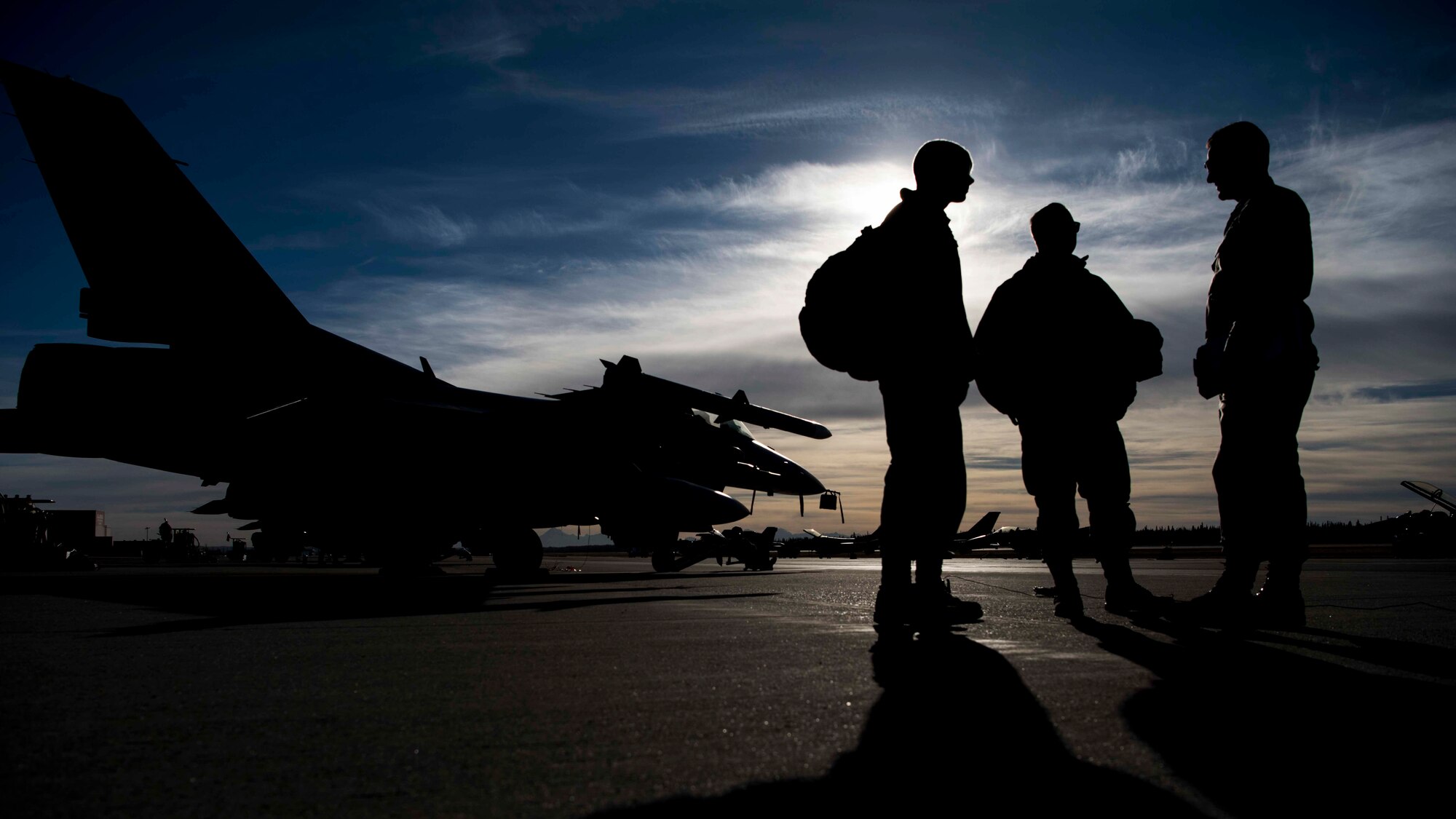U.S. Air Force Senior Airman Cody Fugate, left, a 13th Aircraft Maintenance Unit crew chief, speaks with Staff Sgt. Orin Fitzpatrick, center, a 35th Maintenance Squadron F-16 crew chief, and Tech. Sgt. Michael Zimmermann, right, a 13th Aircraft Maintenance Unit expeditor, during exercise RED FLAG-Alaska 19-1, at Eielson Air Force Base, Alaska, Oct. 9, 2018. While the primary focus of the exercise is ally development and cohesion, Team Misawa maintainers found the training to be beneficial to expanding their skill sets due to the fast-paced operations. (U.S. Air Force photo by Airman 1st Class Collette Brooks)