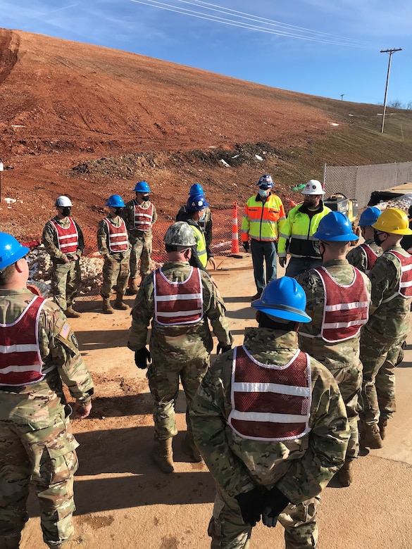 The Fort Leonard Wood Warrant Officers Basic Course received some “hands on training” at the Hospital Replacement project currently under construction, March 3, 2021.

In coordination with the Kansas City District, U.S. Army Corps of Engineers, Design/Build Contractor JE Dunn and their subcontractors, the WOBC students suited-up in their personal protective equipment and were briefed on site by engineering and construction subject matter experts of multiple fields; to include – geotechnical, environmental controls and permitting, surveying, soil classification, detention basins and safety. The group also discussed how to achieve project success, the importance of team collaboration and effective partnering amongst all stakeholders.