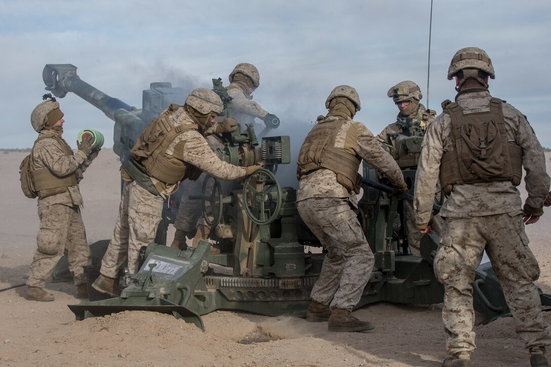 U.S. Marines with Kilo Battery, 2nd Battalion, 10th Marine Regiment, fire an M777 howitzer during  a fire support exercise on Marine Corps Air-Ground Combat Center, Twentynine Palms, Calif., Jan. 21, 2021. The training is part of Integrated Service Level Training Exercise (SLTE) 2-21, a combined arms training exercise intended to produce combat ready forces capable of operating as an integrated Marine Air-Ground Task Force. SLTE 2-21 affords 6th Marine Regiment an opportunity to exercise command and control of warfighting functions from across the Marine Corps and against a live, free thinking, adversary. (U.S. Marine Corps photo by Lance Cpl. Brian Bolin Jr.)