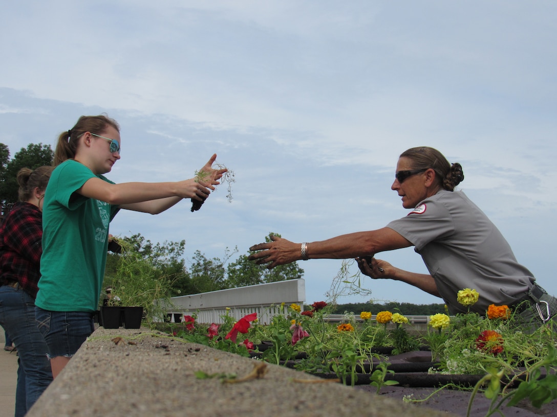 Mark Twain Lake staff are assisted by local schools planting flowers into the flower beds overlooking Clarence Cannon Dam