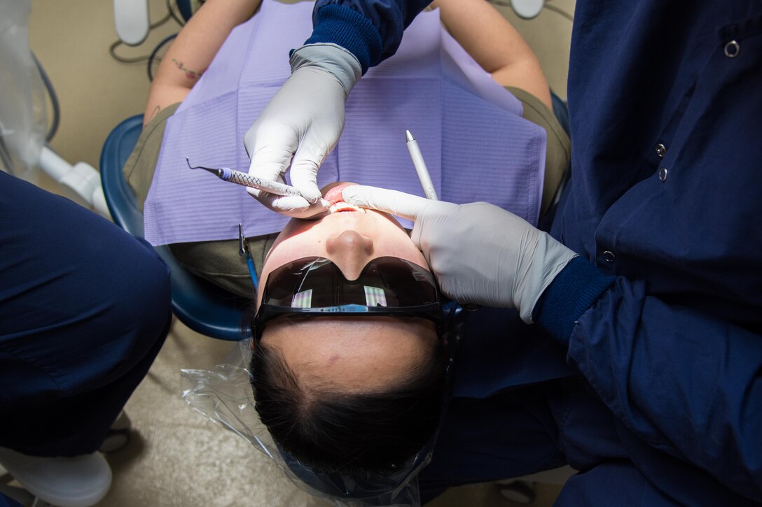 Airman 1st Class Marissa Kruse, 22nd Aircraft Maintenance Squadron crew chief, receives a teeth cleaning Mar. 1, 2021, at McConnell Air Force Base, Kansas. The dental clinic provides a number of services for military members and their dependents including: cleanings, fillings, root canals, retainers, night guards and tooth extractions. (U.S. Air Force photo by Senior Airman Alexi Bosarge)