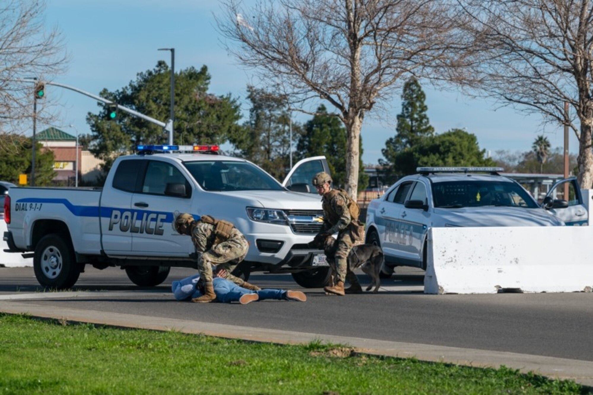 Airmen in bright vests simulate an arrest of a gate runner