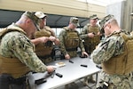 Coast Guard members with Port Security Unit 307 load magazines before completing weapons training at Pinellas County Sheriff's Office firing range in Clearwater, Florida, Nov. 16, 2019. Members with the Clearwater-based unit conduct training to maintain readiness in order to deploy anywhere in the world within 96 hours. U.S. Coast Guard photo by Petty Officer 2nd Class Ashley J. Johnson.