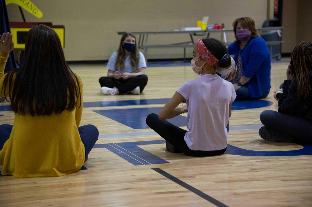 a sitting person begins to throw a ball