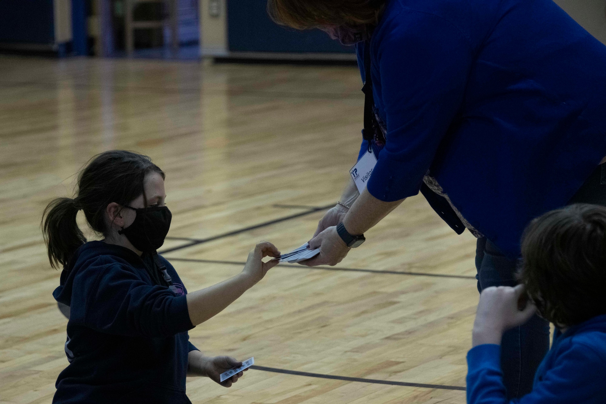 a child takes a card from another person