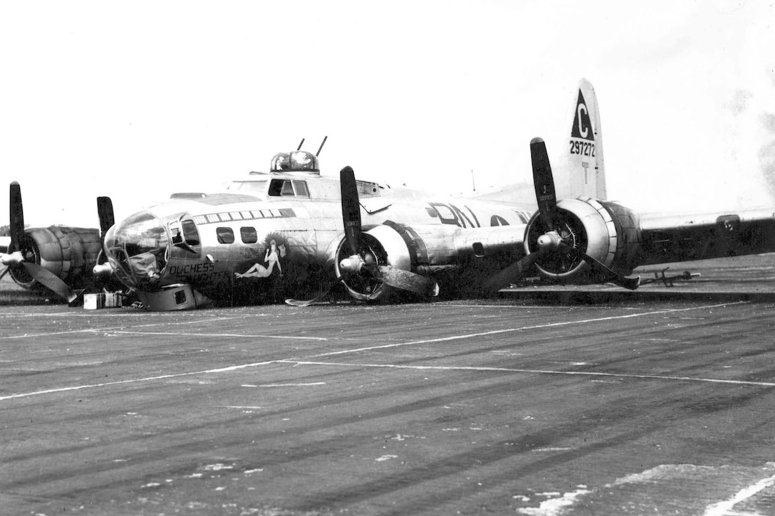 A damaged plane lies on the tarmac.