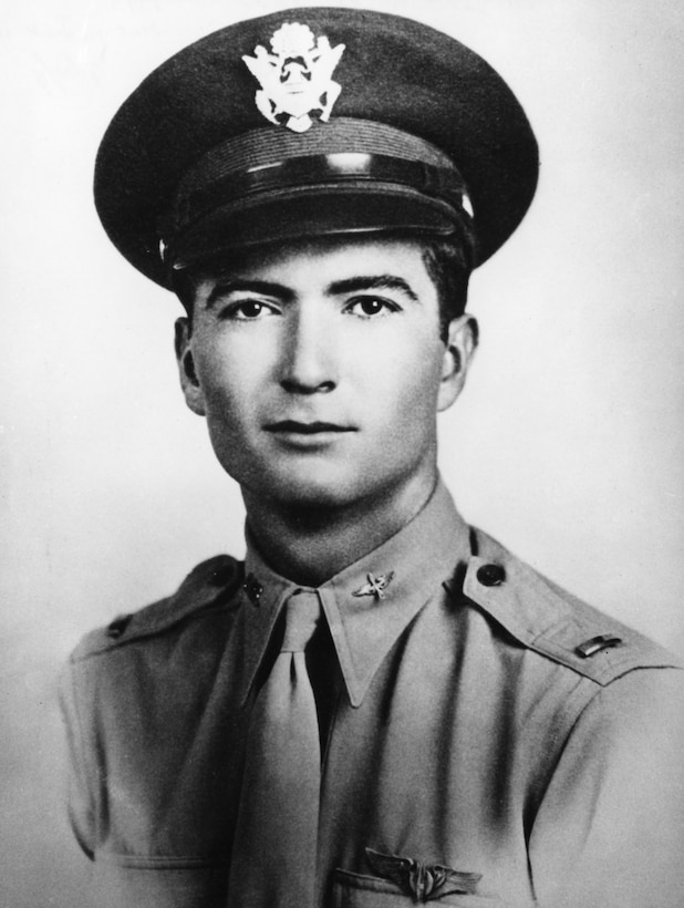 A man in uniform and emblemed cap poses for a photo.