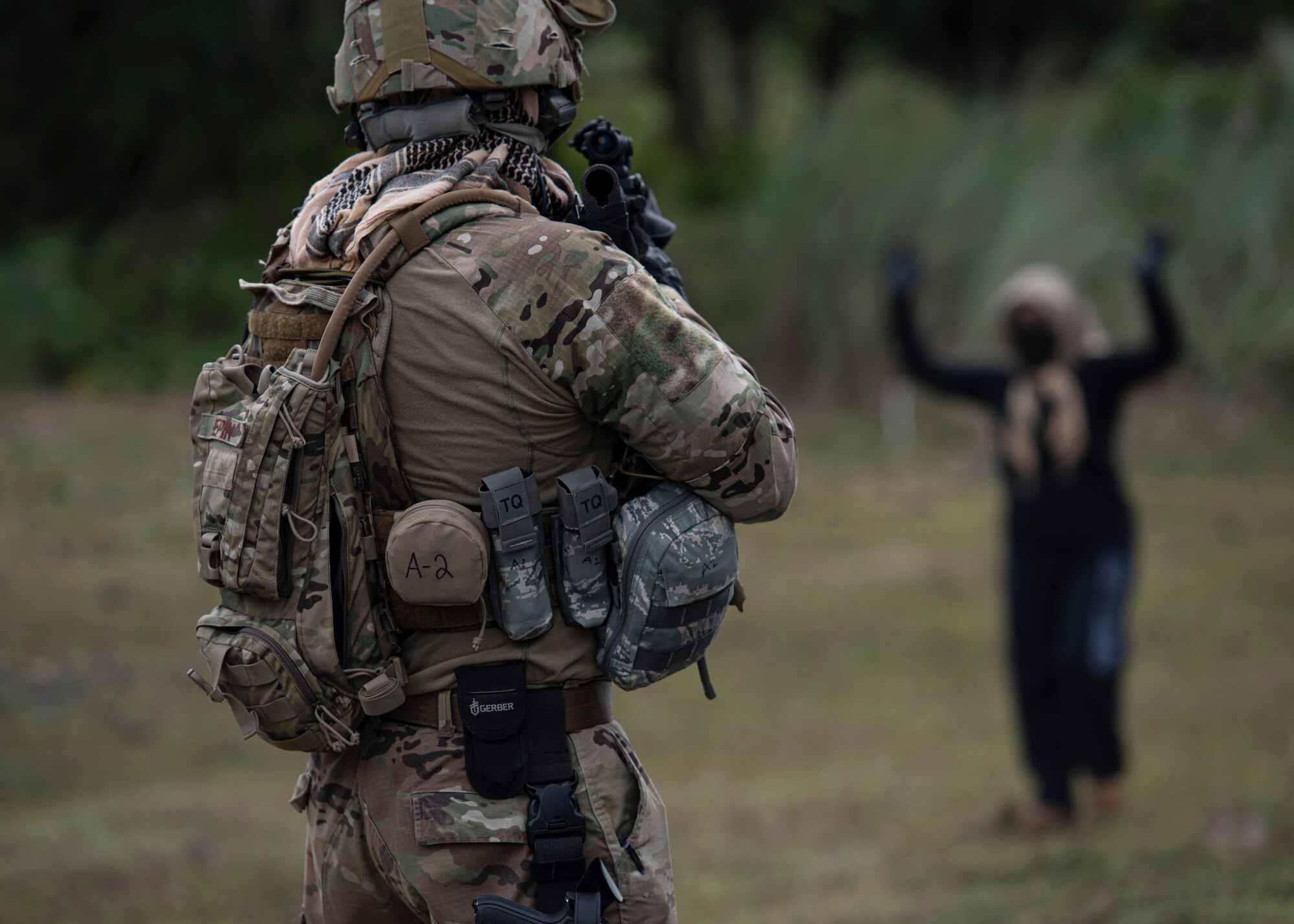 U.S. Air Force Technical Sgt. Adam Pepin, 644th Combat Communications Squadron, apprehends a member of the opposition force during Exercise Dragon Shield at Northwest Field, Guam, January 13, 2021.