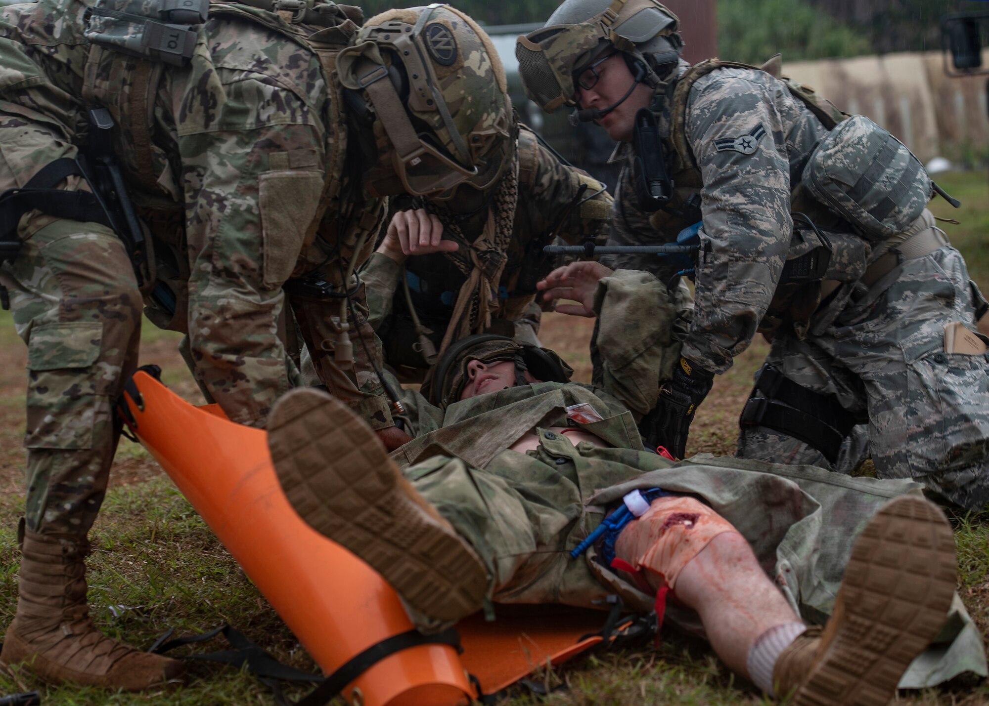U.S. Airmen from the 644th Combat Communications Squadron perform Self Aid Buddy Care during Exercise Dragon Shield at Northwest Field, Guam, January 13, 2021.