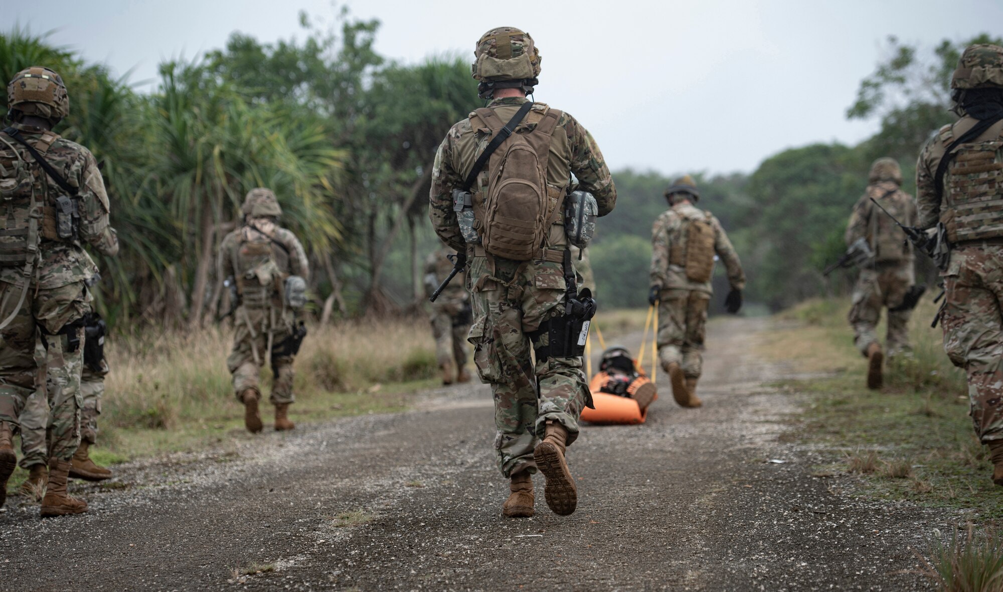 Multi-capable Airmen of the 644th Combat Communications Squadron transport an injured Airman to a field to await an emergency airlift by the Guam Army National Guard medical helicopter during Exercise Dragon Shield at Northwest Field, Guam, January 13, 2021.