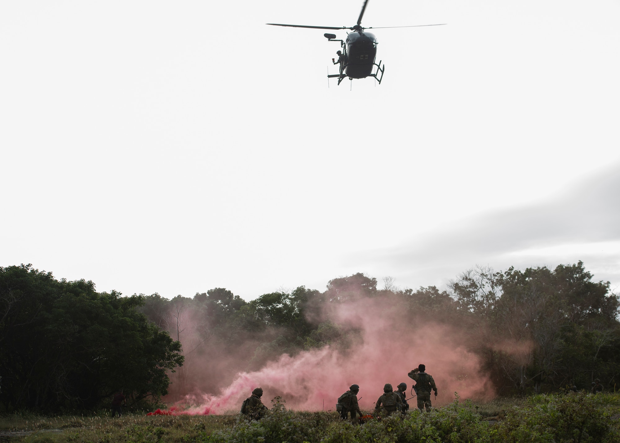 Multi-capable Airmen of the 644th Combat Communications Squadron await the Guam Army National Guard medical helicopter as training during Exercise Dragon Shield at Northwest Field, Guam, January 13, 2021