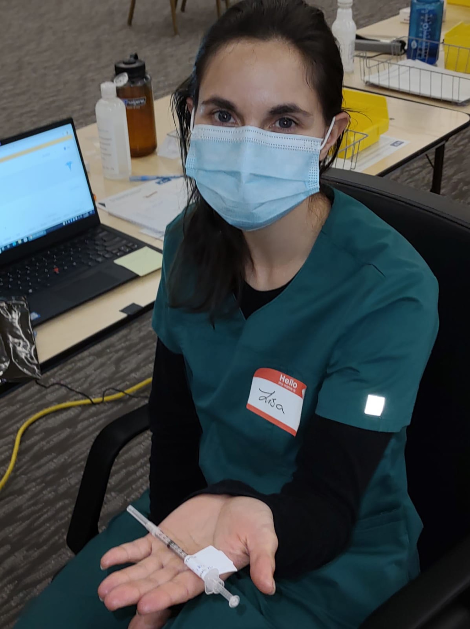 Army Sgt. Lisa Kromer displays a dose of COVID-19 vaccine at the Doubletree Hotel in Burlington, Vermont, March 3, 2021. Kromer is part of the Vermont National Guard's Task Force Coyote, which recently transitioned from offering COVID testing to vaccinations.