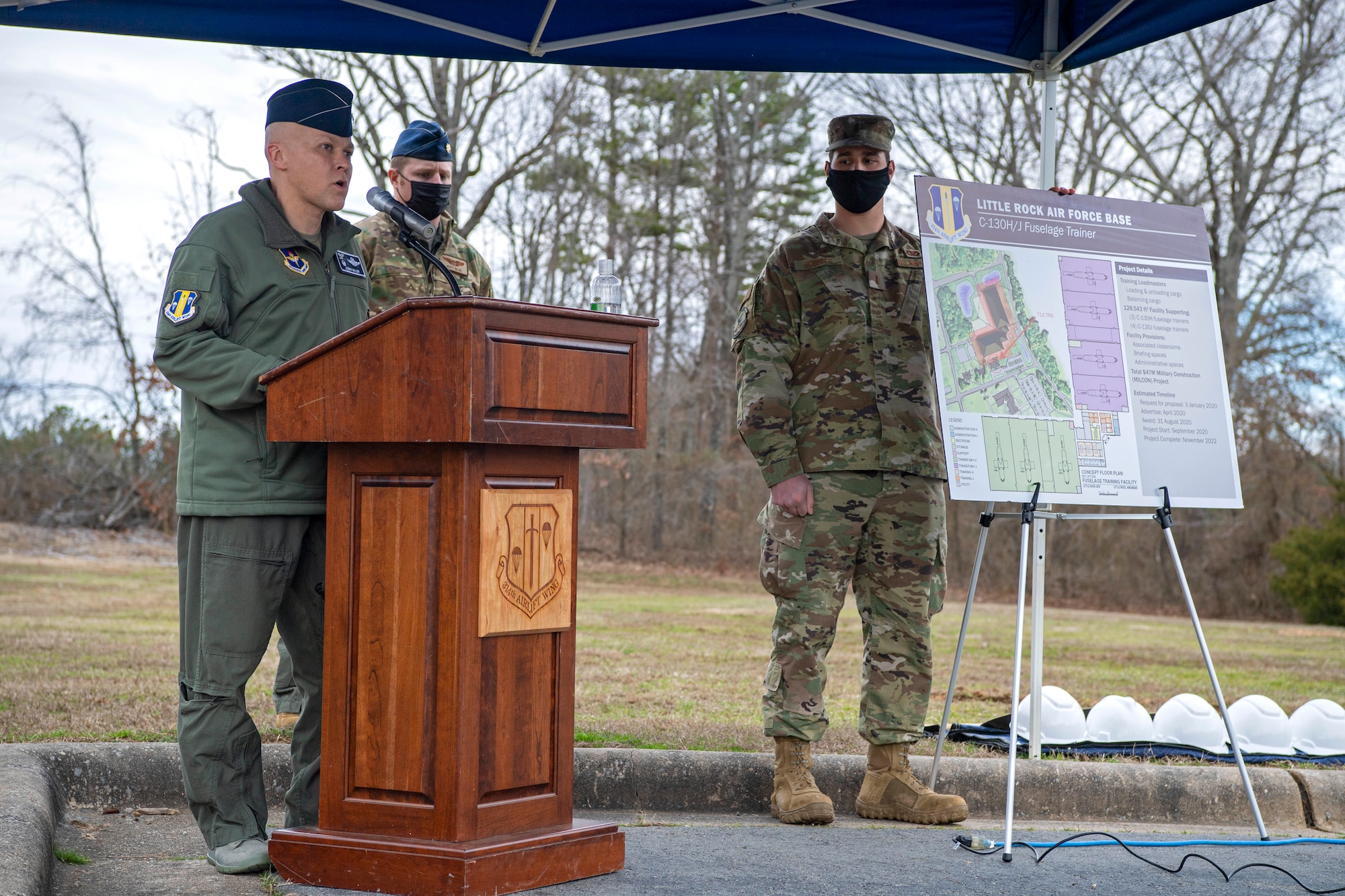 Col. Miller stands at a podium during a groundbreaking ceremony.