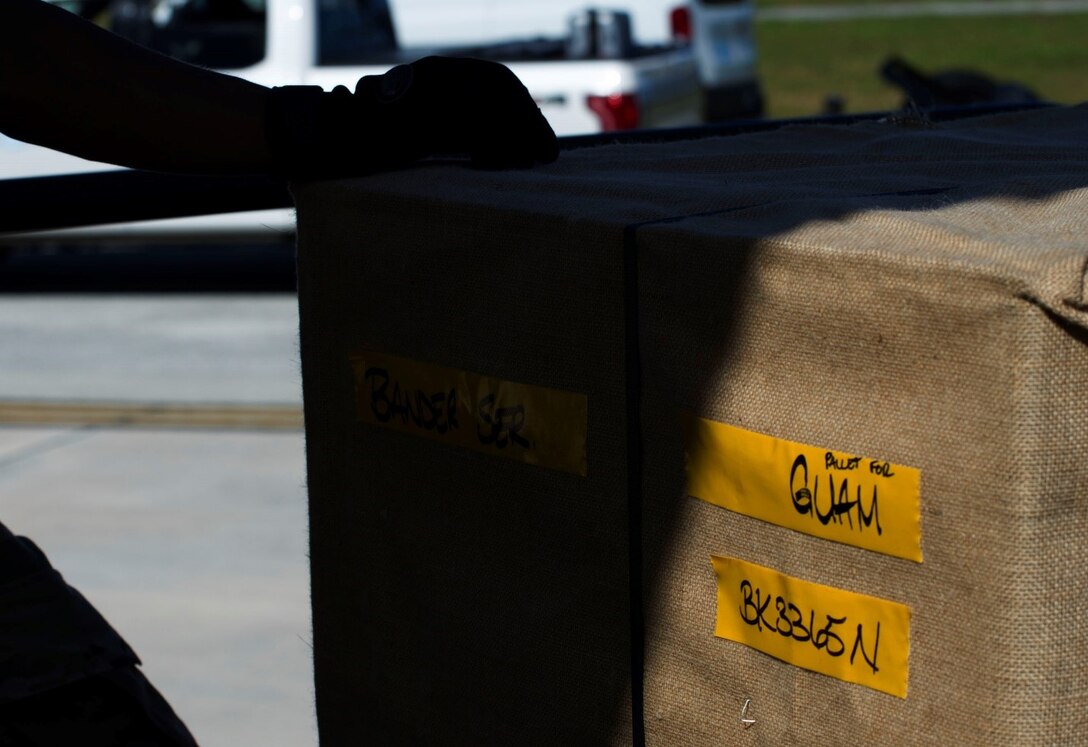 A Department of State COVID-19 refrigerator bound for Andersen Air Force Base, Guam, sits on a Tunner loader awaiting offload onto a flatbed for ground transport on Feb. 23, 2021.