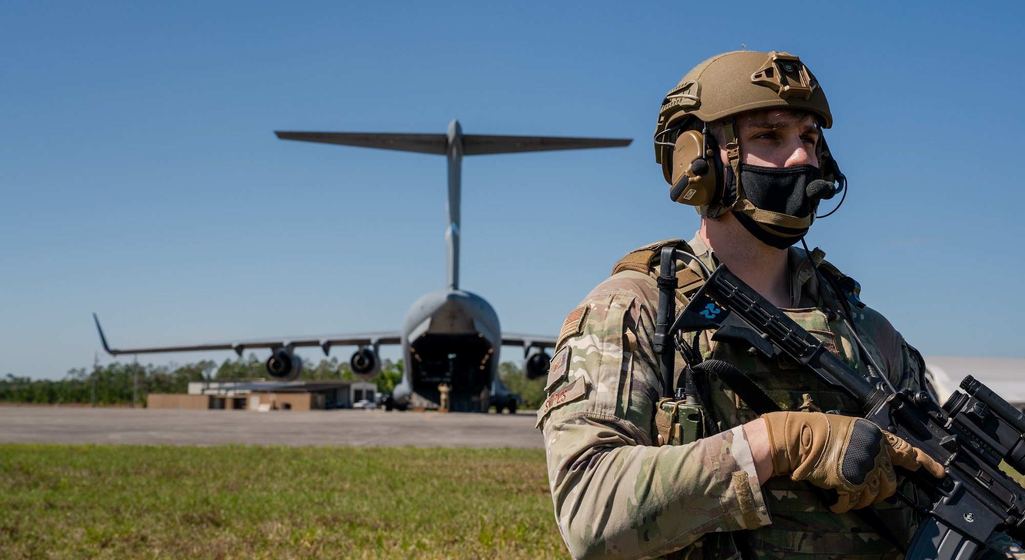Staff Sgt. Matthew Snipes, 23rd Security Forces Squadron resource advisor, Moody Air Force Base, Georgia, guards a Dover AFB C-17 Globemaster III during Exercise Mosaic Tiger, at Avon Park Air Force Range, Florida, Feb. 23, 2021. Mosaic Tiger is an agile combat employment exercise designed to test multi-capable Airmen integrating mission-essential skills with minimal resources, so Airmen can continue to support combat operations. (U.S. Air Force photo by Airman 1st Class Faith Schaefer)