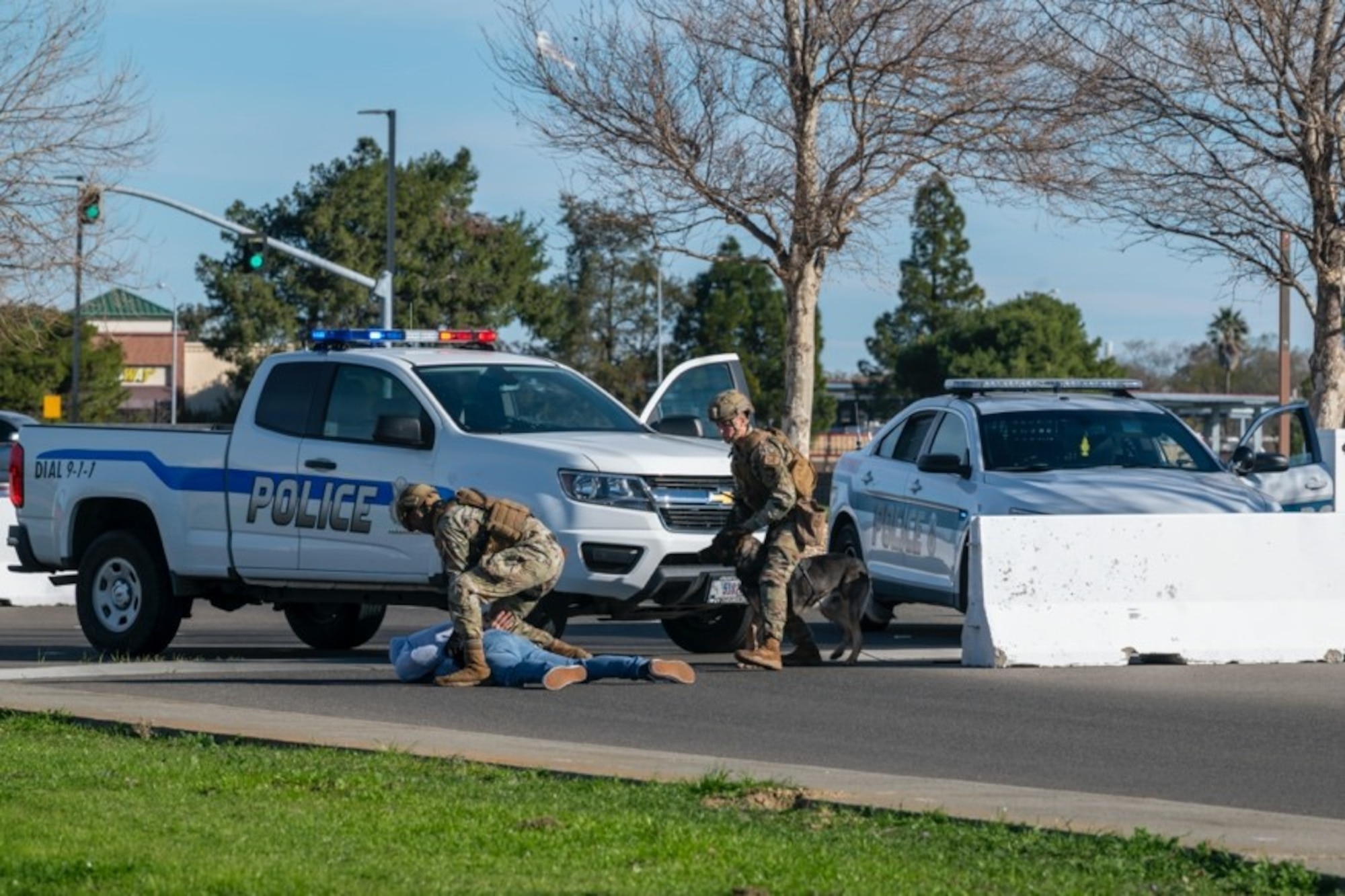 Airmen in bright vests simulate an arrest of a gate runner