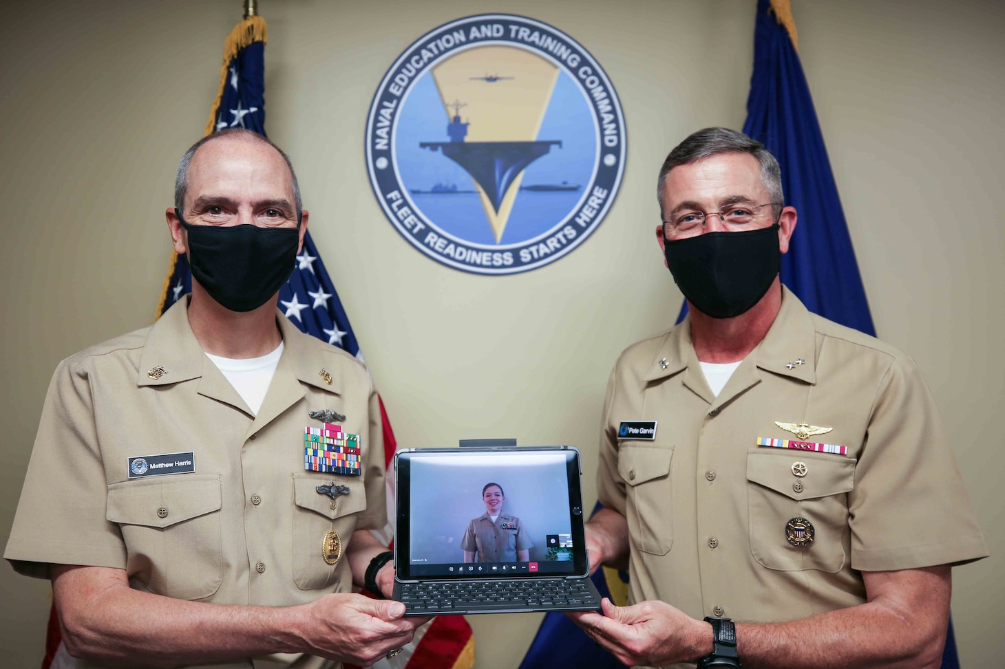 Rear Adm. Pete Garvin, commander, Naval Education and Training Command (NETC), right, and Force Master Chief Matthew Harris, recognize Lt. Carolee Dearman, formerly assigned to University of Illinois NROTC, Champaign, Illinois, as the 2020 MyNavy HR Force Development domain NROTC military instructor of the year (MIOY). The NETC MIOY program recognizes Sailors throughout the domain who exhibit attributes, such as sustained superior performance, leadership, mentorship, knowledge and teaching of military history and heritage, self-improvement, command and community involvement, and exemplary military bearing. (U.S. Navy photo by Genevieve McGee)